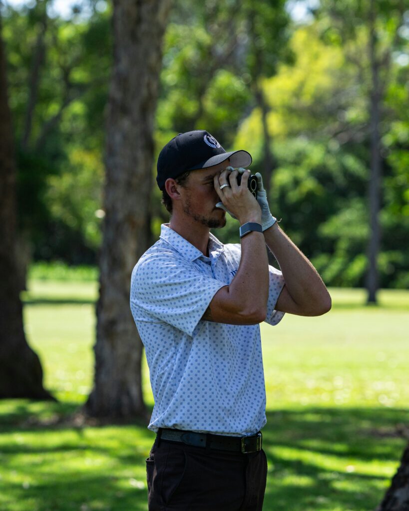 A golf laser rangefinder sitting on a cart for the knowing your numbers golf tech guide.